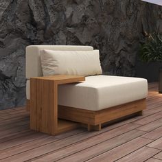 a couch sitting on top of a wooden floor next to a stone wall