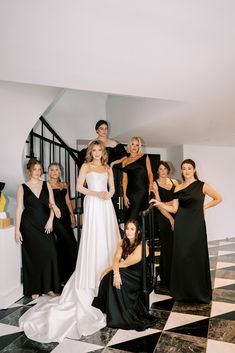 a group of women standing next to each other on a black and white checkered floor