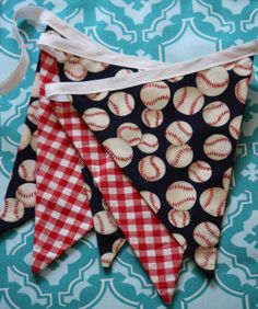 three red and white gingham buntings with baseballs printed on them