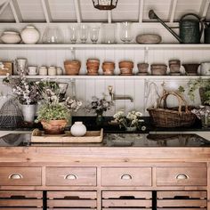 a kitchen with lots of pots and pans on the shelves