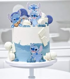 there is a cake decorated to look like stitchers and other characters on the frosting