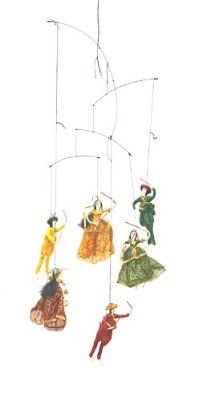 a group of people that are hanging from a wind chime in the shape of dancers