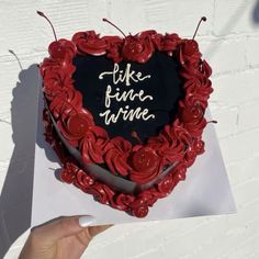 a heart shaped cake with red roses on it