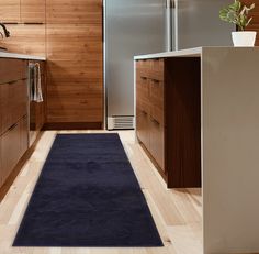 a blue rug in the middle of a kitchen