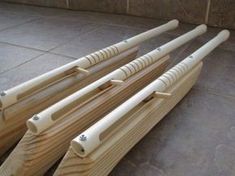 four wooden poles are lined up on the floor