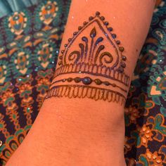 a woman's arm with a henna tattoo on it