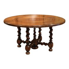 an oval wooden table with spiral legs