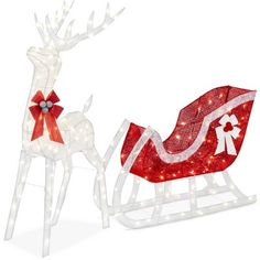 two lighted reindeer sleighs with red bows and lights on them, one in the shape of a santa's sleigh