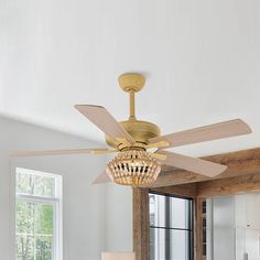 a living room with a ceiling fan and chandelier hanging from it's ceiling