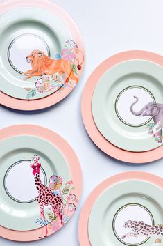 three plates with animals painted on them and one has an elephant, giraffe, and zebra