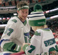 two hockey players are talking to each other