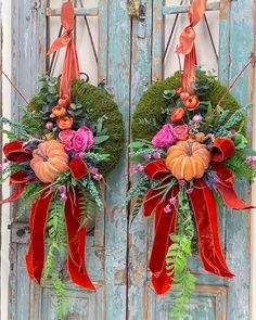 two wreaths decorated with flowers and greenery