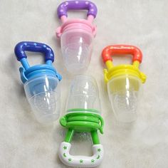 four different colored baby bottles with handles on the top one has a handle and two are empty