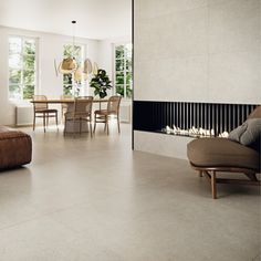 a living room filled with furniture and a fire place next to a dining room table