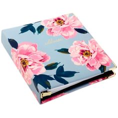 a blue notebook with pink flowers on the cover and gold lettering that says, personalized