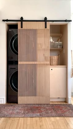 a washer and dryer in a room with wood paneling on the doors