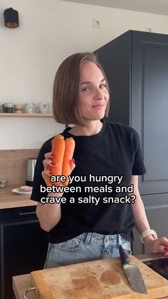 a woman holding two carrots in one hand and a knife in the other with text on it