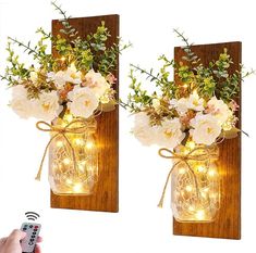 two mason jars with flowers and fairy lights