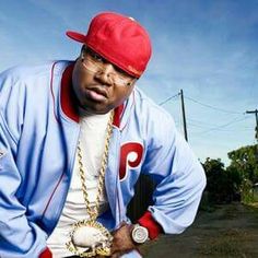 a man in a blue jacket and red hat with a baseball glove on his hand