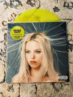 a yellow vinyl record with a blonde woman's face on it and the cover