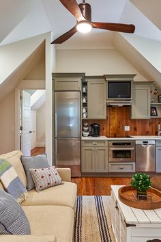 a living room filled with furniture and a ceiling fan