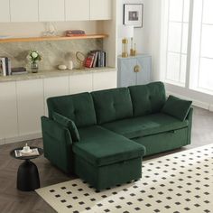 a green couch sitting on top of a white rug