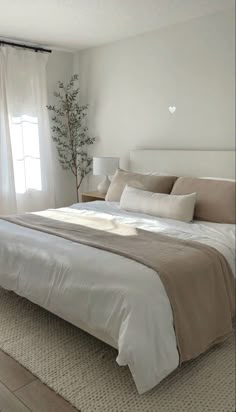 a bedroom with a large bed and white walls