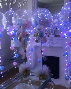 balloons and streamers are on display in front of a fireplace