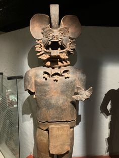 an old statue is on display in a museum