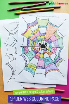 spider web coloring page with markers and pencils