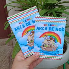 two children's books in front of a potted plant, with the title arca de w