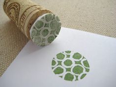 a close up of a piece of paper with a stamp on it and an object in the background