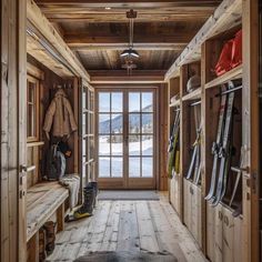 the inside of a wooden cabin with snowboards and skis