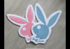 a pair of bunny ears rugs sitting on top of a wooden floor