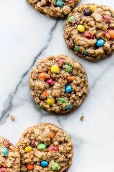 cookies with m & m's and chocolate chips are on a marble countertop