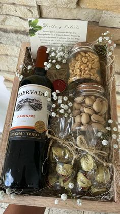 a bottle of wine sitting next to some nuts