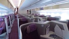 the inside of an airplane with purple seats