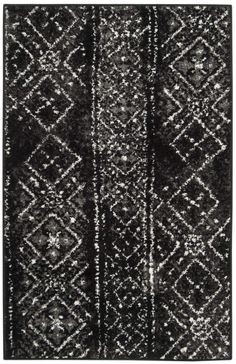 a black and white rug with an abstract design