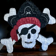 a paper mache skull with a pirate hat