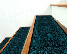 an area rug on the bottom of stairs with writing on the wall in the background