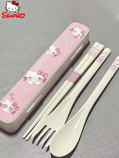 hello kitty utensils and spoons in a pink plastic case with hello kitty on the side