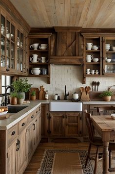 a kitchen filled with lots of wooden cabinets and counter top space next to a dining room table