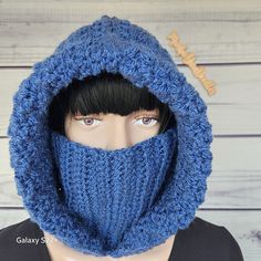 a mannequin head wearing a blue knitted hood