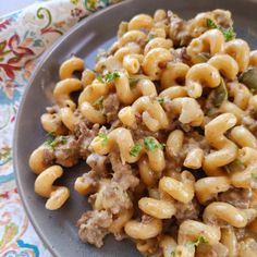 a plate full of macaroni and cheese with meat