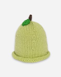 a knitted hat with a green leaf on top