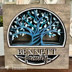 a wooden sign with the words, bennet family on it and a tree in the center