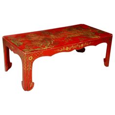 a red bench with gold designs on the top and bottom, sitting in front of a white background