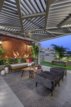 an outdoor living area with couches and tables