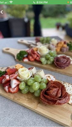 two wooden cutting boards topped with different types of food