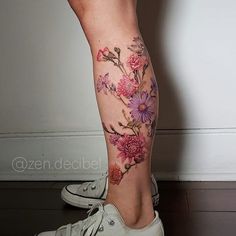 a woman's leg with flowers painted on it